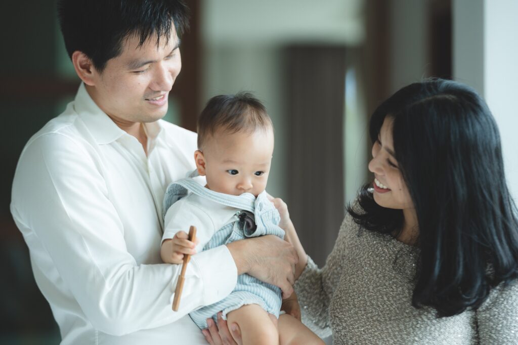 young Asian family are happy together at home by life insurance